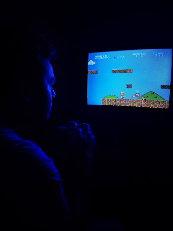 Man playing Super Mario Bros on TV, capturing retro gaming nostalgia.